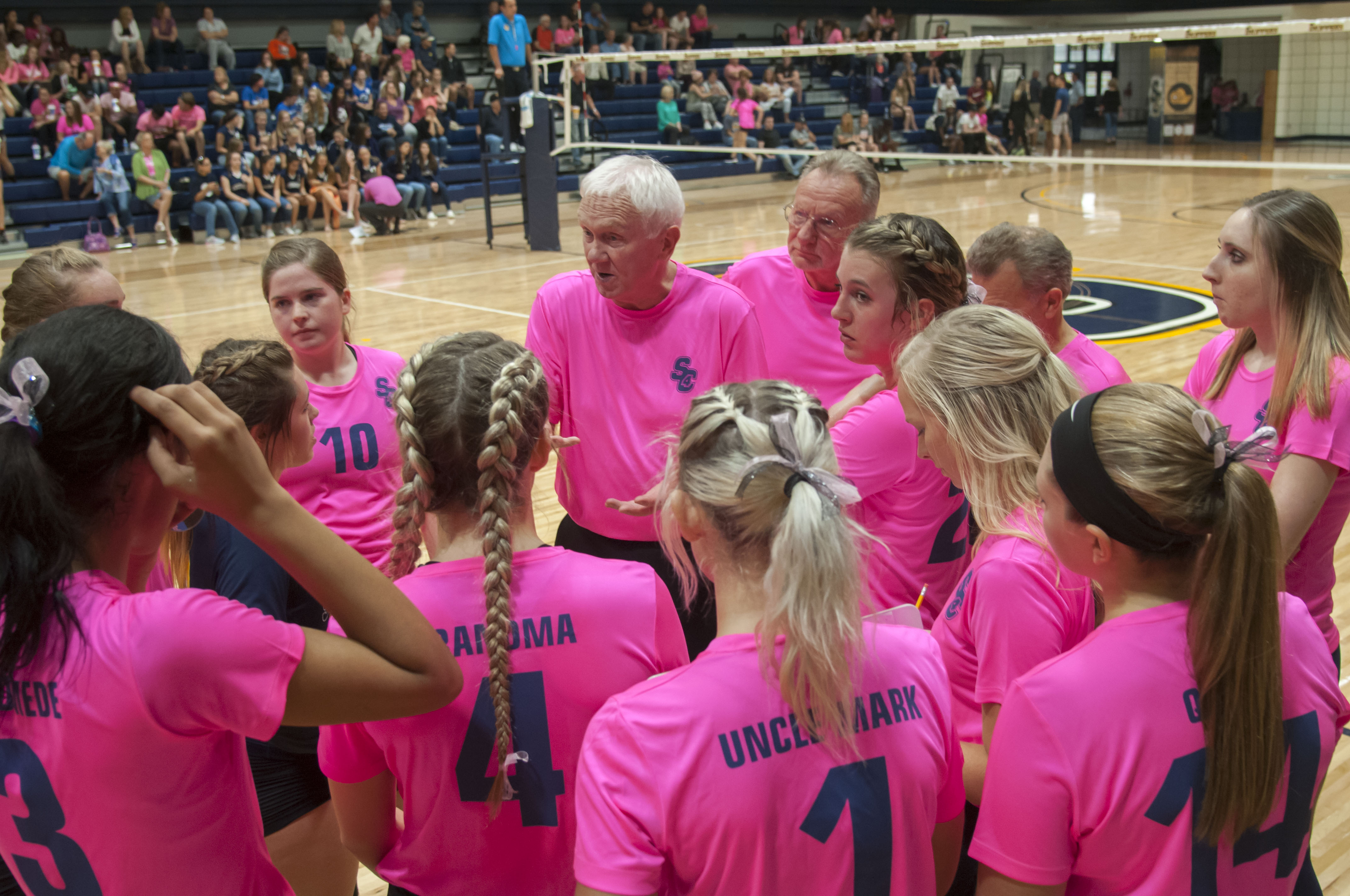 Skipper volleyball team talking with coaches