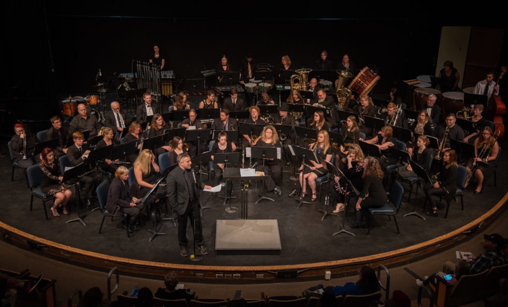 SC4 symphonic band pictured on stage in the Fine Arts Theatre. 