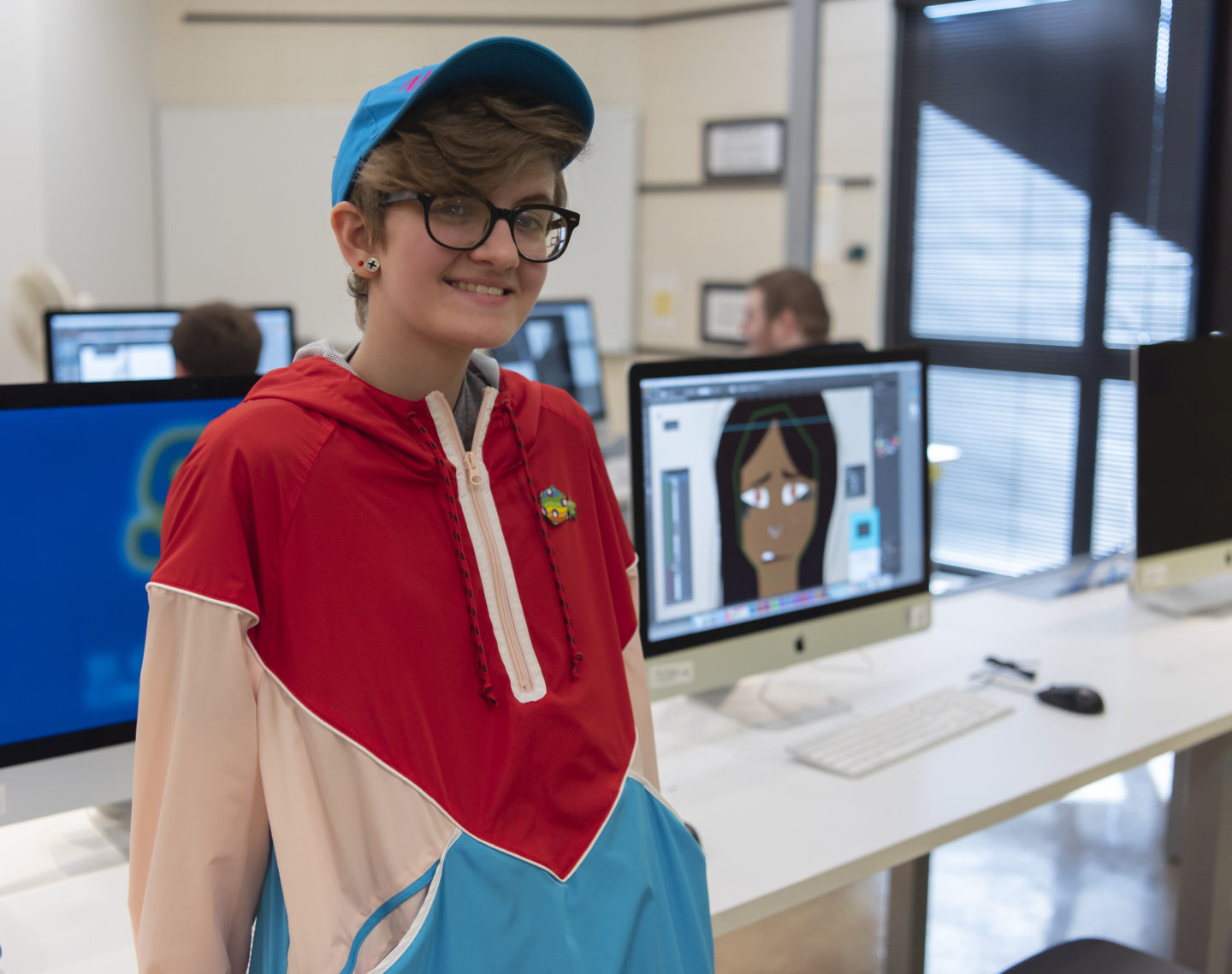 Student at computer in graphic design class