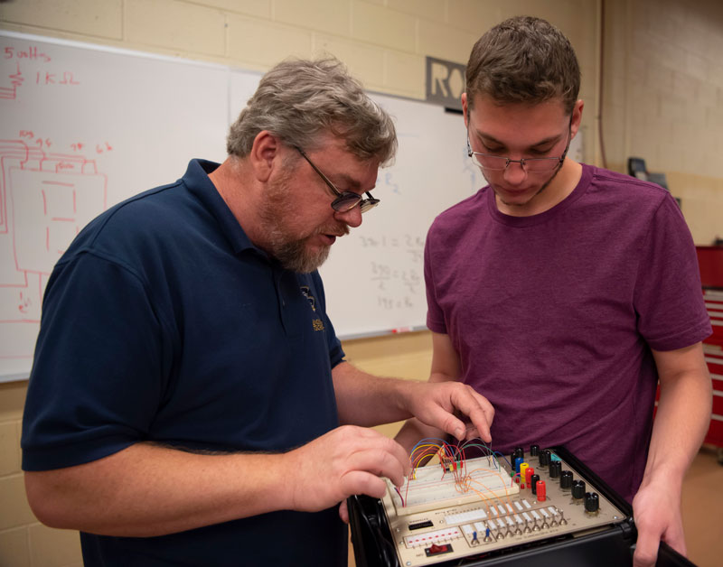 Instructor helps an engineering tech student