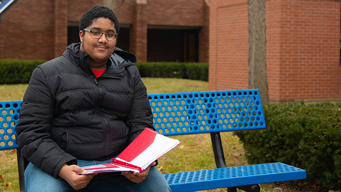 Blue Water Student sits