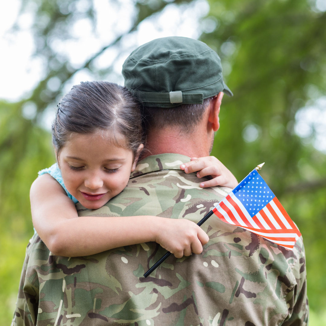 Veteran and little girl hugging