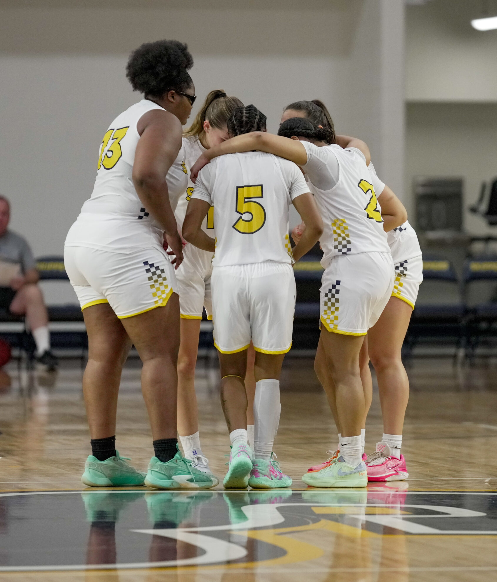 SC4 Women’s Basketball athletes in a  team huddle 