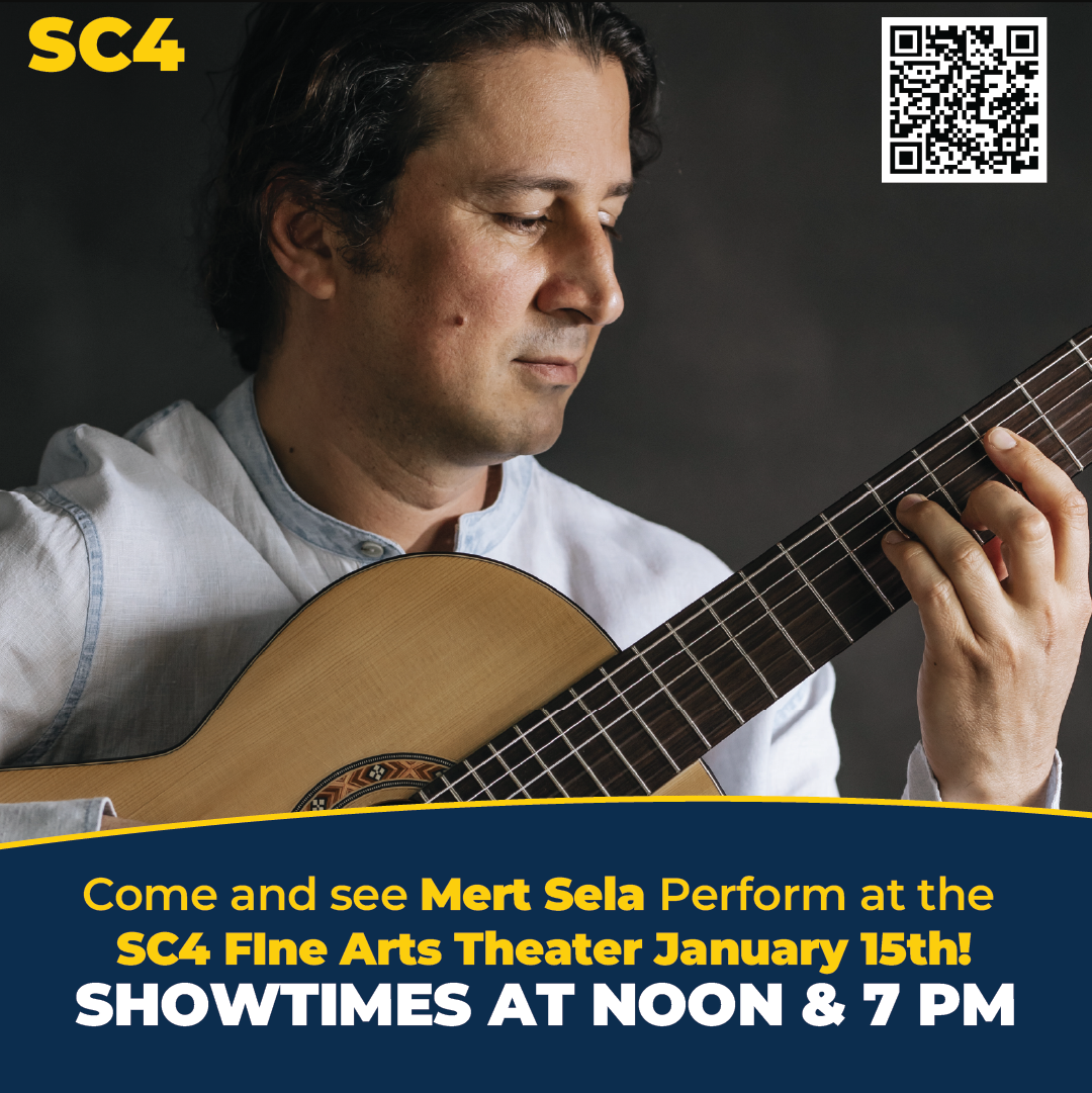 Performer Mert Sela playing a guitar. 