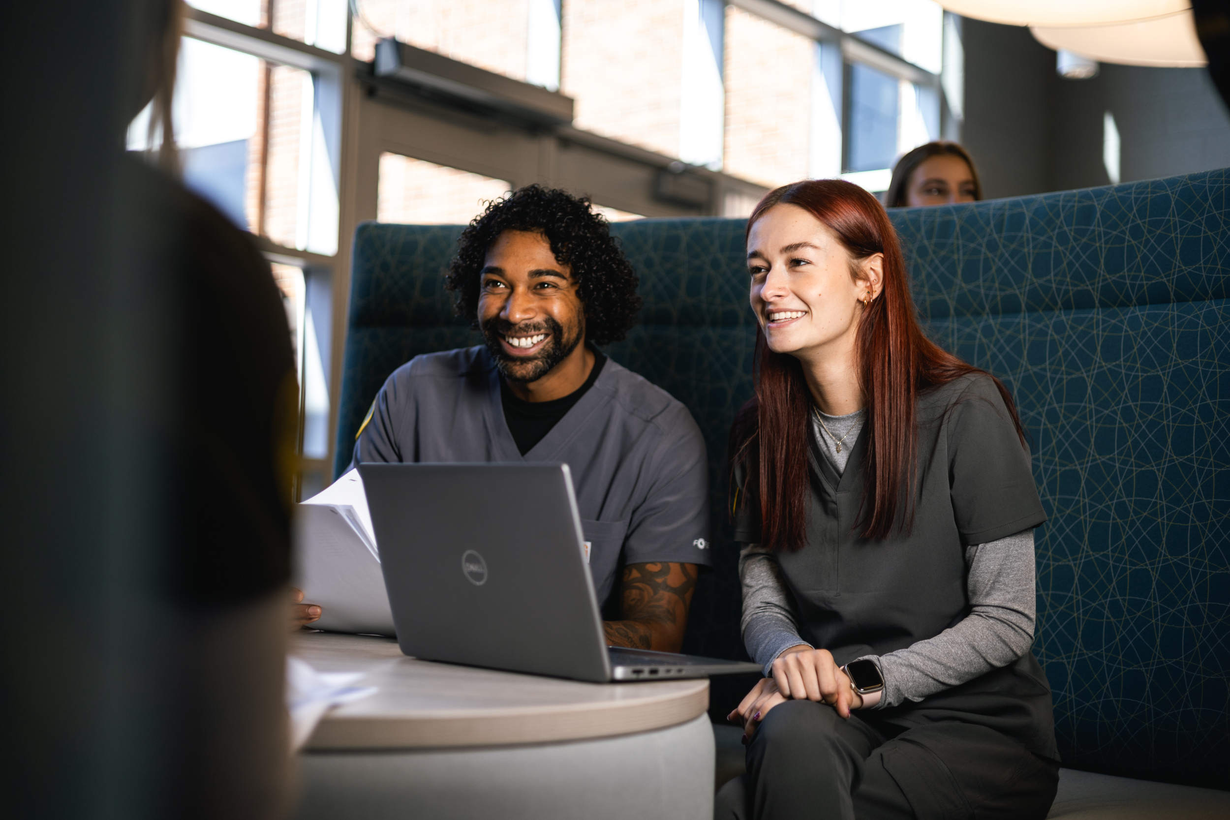Two students having a conversation in a lounge. 