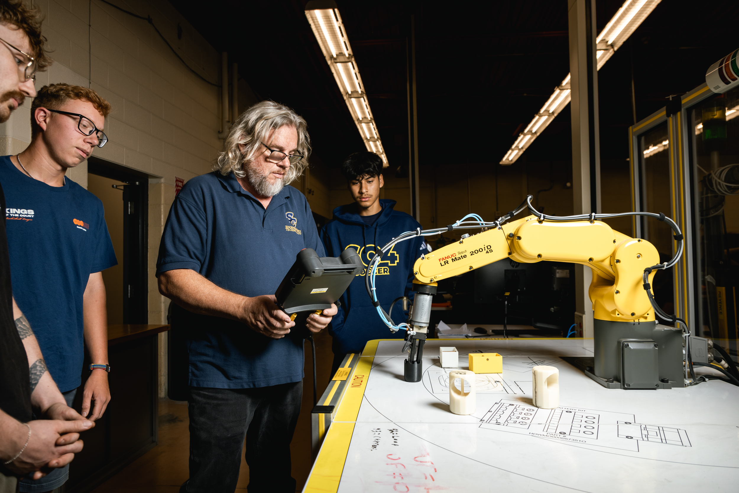 Instructor helps an engineering tech student