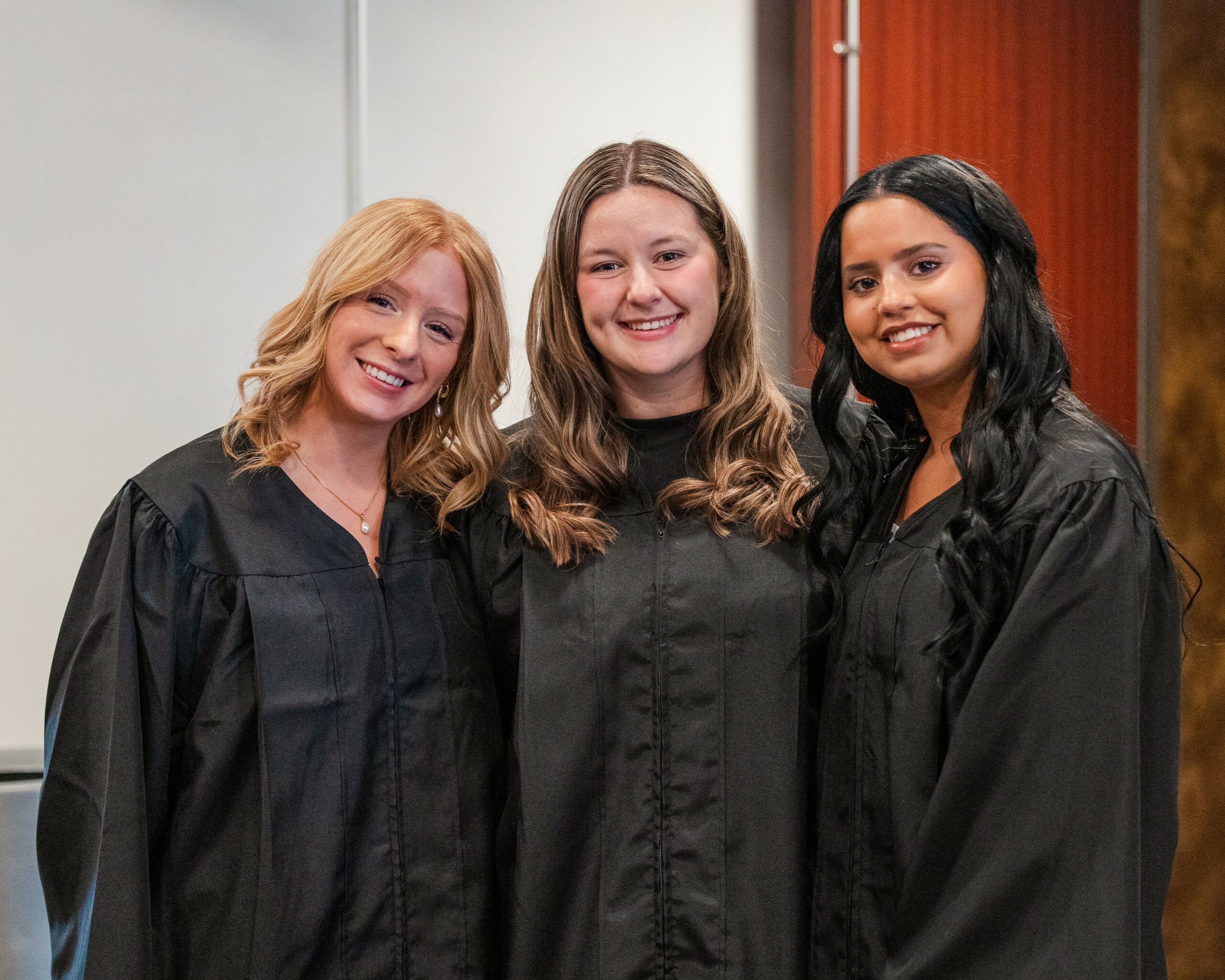 three students at commencement