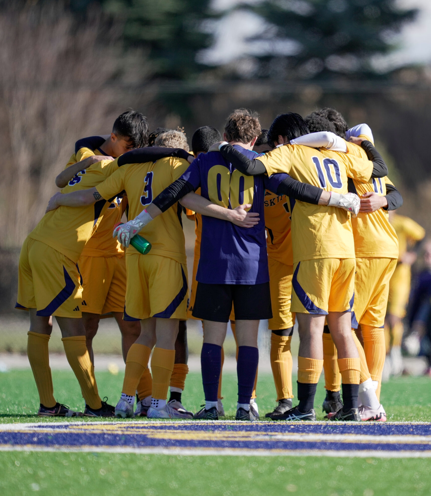 SC4 men's soccer team in a huddle
