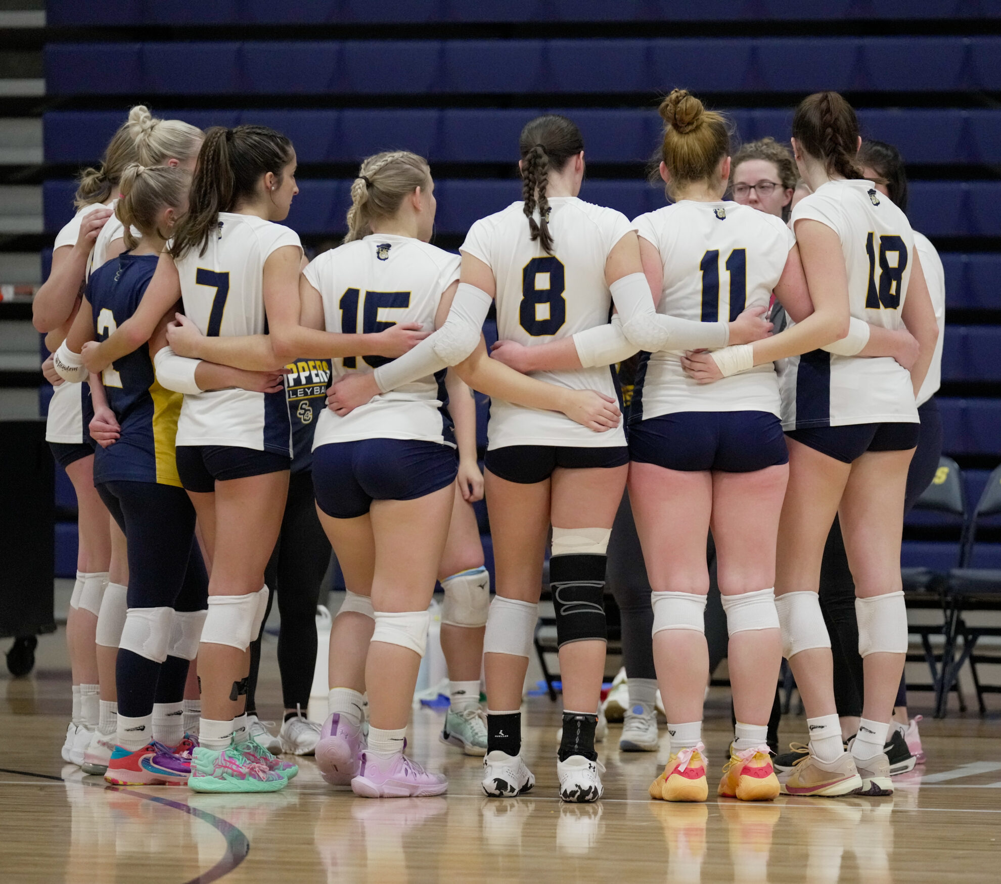 SC4 volleyball team in a huddle
